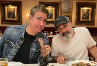 Kenny and Spenny sitting together at dinner.